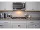 Modern kitchen featuring stainless steel appliances, granite countertops, and white subway tile backsplash at 2010 Saddlebred Dr, Iron Station, NC 28080