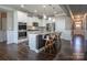 Kitchen featuring a granite island, stainless steel appliances, and barstool seating at 2010 Saddlebred Dr, Iron Station, NC 28080