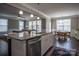 Open-concept kitchen island with granite countertops connecting to the living and dining areas at 2010 Saddlebred Dr, Iron Station, NC 28080
