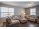 Inviting living room with plush sofas and an ottoman, perfect for relaxing and entertaining guests at 2010 Saddlebred Dr, Iron Station, NC 28080