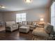 Inviting living room with plush sofas and an ottoman, perfect for relaxing and entertaining guests at 2010 Saddlebred Dr, Iron Station, NC 28080