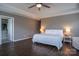 Spacious main bedroom suite with hardwood floors, two lamps, and an en suite bathroom at 2010 Saddlebred Dr, Iron Station, NC 28080