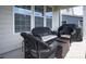 Covered patio with wicker seating and a small table perfect for outdoor relaxing and entertaining at 2010 Saddlebred Dr, Iron Station, NC 28080