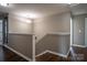 Stairway with hardwood flooring, white trim, and neutral wall color with pendant lighting at 2010 Saddlebred Dr, Iron Station, NC 28080