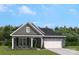 Charming single-Gathering home featuring stone accents, a welcoming front porch, and a two-car garage at 2033 Mantle Ridge Dr, Indian Trail, NC 28079