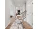 Bright hallway featuring hardwood floors, leading to an open-concept living area with a fireplace at 2033 Mantle Ridge Dr, Indian Trail, NC 28079