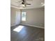 Bedroom with tray ceiling, ceiling fan and large window at 2037 Powerline Dr, Gastonia, NC 28054