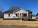 Charming single-story home featuring a classic covered front porch and neatly landscaped yard at 2037 Powerline Dr, Gastonia, NC 28054
