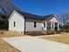 A charming home with a well-maintained lawn, a concrete driveway, and a inviting front porch at 2037 Powerline Dr, Gastonia, NC 28054