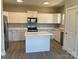 Bright kitchen with white cabinets, stainless steel appliances and a center island at 2037 Powerline Dr, Gastonia, NC 28054