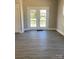 Spacious living room with hardwood floors and access to the backyard through a set of double doors at 2037 Powerline Dr, Gastonia, NC 28054