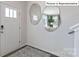 Bright entryway featuring a modern rug, stylish decorative mirrors, and a white front door with glass accents at 2056 Harlequin Dr, Indian Trail, NC 28079