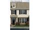 Charming two-story townhome featuring black shutters and a well-maintained landscaped front yard at 2056 Harlequin Dr, Indian Trail, NC 28079