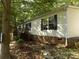 Charming home featuring brick foundation, black shutters, and inviting wooden deck at 2130 Babbling Brook Ln, Gastonia, NC 28052