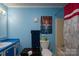 A blue-themed bathroom featuring a sink, toilet, and shower-tub combo at 214 Harrel St, Salisbury, NC 28144