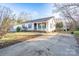 Charming single-story home with a concrete driveway, small porch, and well-manicured front yard at 214 Harrel St, Salisbury, NC 28144