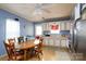 A kitchen-dining space with a ceiling fan, white cabinets, linoleum floor, and a round table with chairs at 214 Harrel St, Salisbury, NC 28144