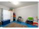 Functional room with blue flooring, storage shelves, and containers for organization at 214 Harrel St, Salisbury, NC 28144