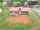 Aerial view of a charming home with red roof, large yard, fence, and private deck at 2180 Grace Church Rd, Salisbury, NC 28147