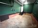Spacious basement featuring concrete flooring, painted walls, stairs, and a garage door at 2180 Grace Church Rd, Salisbury, NC 28147