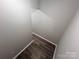 Clean hallway with modern flooring and neutral paint, offering a simple and bright transition space at 2180 Grace Church Rd, Salisbury, NC 28147