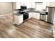 Renovated kitchen featuring stainless steel appliances, white cabinets and stone countertops at 2180 Grace Church Rd, Salisbury, NC 28147