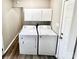 Bright laundry room features a modern washer and dryer with convenient overhead cabinets at 2180 Grace Church Rd, Salisbury, NC 28147