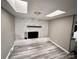 Cozy living room showcasing a painted brick fireplace with stylish flooring and natural light at 2180 Grace Church Rd, Salisbury, NC 28147