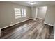 Bright living room with vinyl wood flooring, a large window, and neutral walls at 2180 Grace Church Rd, Salisbury, NC 28147