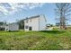 Expansive backyard featuring lush green grass, exterior of the two-story home, and a concrete driveway at 2583 Watson Dr, Lancaster, SC 29720