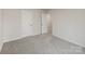 Neutral bedroom featuring plush carpet, a closet, and doors leading to other areas of the home at 2583 Watson Dr, Lancaster, SC 29720