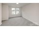 A bright, empty bedroom with neutral carpeting and plenty of natural light at 2583 Watson Dr, Lancaster, SC 29720