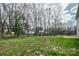Large grassy backyard with mature trees creating a serene and private outdoor space at 2591 Watson Dr, Lancaster, SC 29720