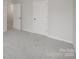 This bedroom has neutral carpeting, and light walls with white trim and doors at 2591 Watson Dr, Lancaster, SC 29720