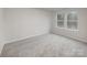 Bright bedroom with neutral carpet, paint, and two large windows at 2591 Watson Dr, Lancaster, SC 29720