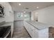 Kitchen with a granite island, stainless steel appliances, and hardwood floors, adjacent to the sunny living room at 2591 Watson Dr, Lancaster, SC 29720