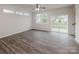 Bright, open-concept living room with contemporary floors, large windows, and a sliding glass door to the backyard at 2591 Watson Dr, Lancaster, SC 29720