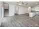 Spacious open-concept living room featuring wood floors, a staircase, and a kitchen island with granite countertops at 2591 Watson Dr, Lancaster, SC 29720