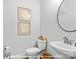 Stylish half bathroom featuring a vessel sink, round mirror, and decorative wall art at 276 Gilead Rd, Huntersville, NC 28078