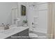 Bathroom featuring a gray vanity with a white countertop and a shower and tub with white tile at 276 Gilead Rd, Huntersville, NC 28078