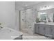 Elegant bathroom featuring a glass-enclosed shower, double vanity, and tiled walls at 276 Gilead Rd, Huntersville, NC 28078