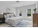 Bedroom with two windows, a bed with decorative pillows, and a blue rug at 276 Gilead Rd, Huntersville, NC 28078