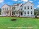 Charming townhomes with pastel exteriors, white picket fences, and lush green lawns at 276 Gilead Rd, Huntersville, NC 28078