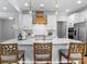 Bright kitchen features a large island with chairs, white cabinets, and stainless steel appliances at 276 Gilead Rd, Huntersville, NC 28078