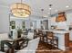 Open-concept kitchen boasts island seating, modern lighting, and seamless flow to the living area at 276 Gilead Rd, Huntersville, NC 28078