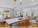 Open concept kitchen with island, stainless appliances, and seamless flow to dining and living area at 276 Gilead Rd, Huntersville, NC 28078