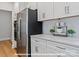 Modern kitchen featuring stainless steel appliances, white cabinets, and quartz countertops at 276 Gilead Rd, Huntersville, NC 28078