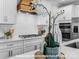 Modern kitchen with white cabinets, stainless steel appliances, and wooden range hood at 276 Gilead Rd, Huntersville, NC 28078