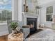Comfortable living room featuring a black fireplace, mantel, decor, and natural light at 276 Gilead Rd, Huntersville, NC 28078
