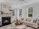 Cozy living room features a fireplace with mantle, neutral tones and lots of natural light at 276 Gilead Rd, Huntersville, NC 28078